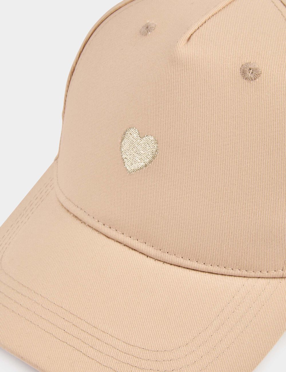 Geborduurde pet beige vrouw